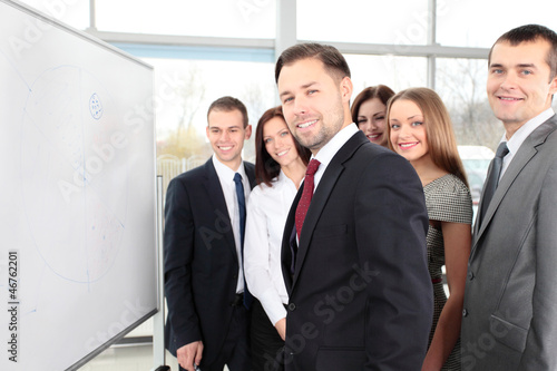 Photo: Business people looking at their leader while he explaining Business people looking at their leader while he explaining