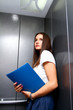 Young business woman in a lift