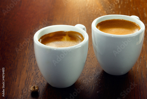 Photo: Two espressos with a single coffee bean Two espressos with a single coffee bean