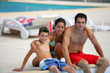 Family sitting by a pool