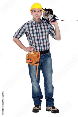 Photo: Man confidently holding circular saw Man confidently holding circular saw