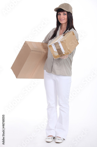 Photo: Mail carrier delivering a package Mail carrier delivering a package