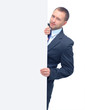 Happy smiling young business man showing blank signboard