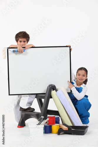 Photo: Two children pretending to be decorating Two children pretending to be decorating