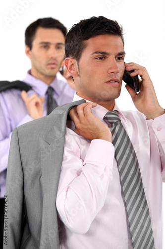 Photo: Businessmen talking on their mobile phones Businessmen talking on their mobile phones