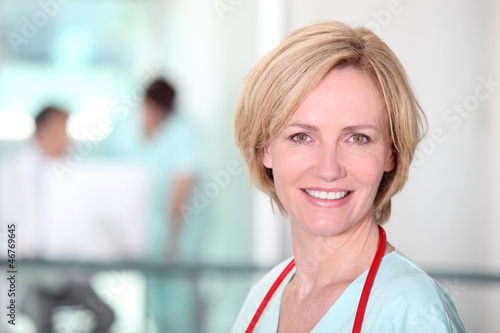 Photo: Female nurse in corridor Female nurse in corridor