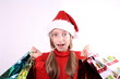 Enthusiastic girl as Mrs. Santa with shopping bags