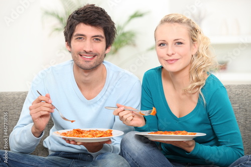 Photo: couple having dinner on the couch couple having dinner on the couch