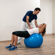 Photo: Woman exercising with her personal trainer at the Gym. Woman exercising with her personal trainer at the Gym.