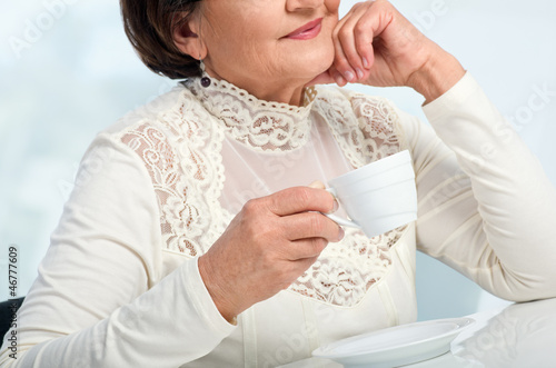 Photo: Senior Woman enjoying cup of coffe Senior Woman enjoying cup of coffe