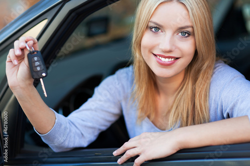 Photo: Woman Showing off New Car Keys Woman Showing off New Car Keys