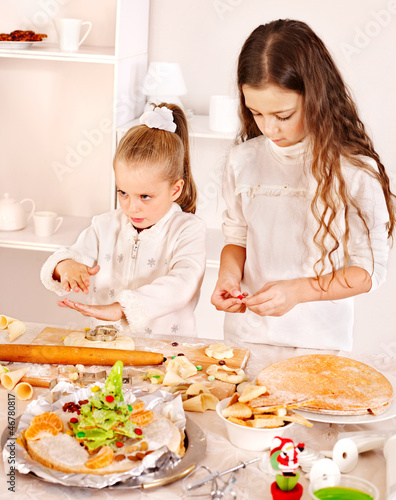 Photo: Children rolling dough in kitchen. Children rolling dough in kitchen.