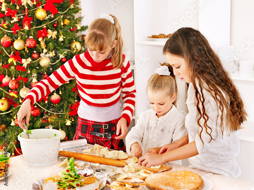 Photo: Children rolling dough in kitchen. Children rolling dough in kitchen.