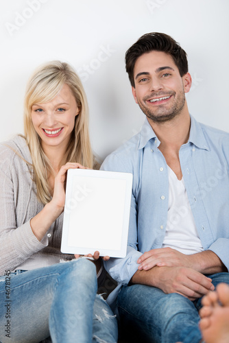 Photo: glückliches paar zeigt tablet-pc glückliches paar zeigt tablet-pc