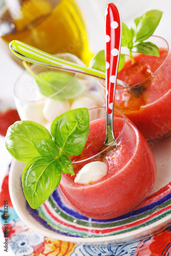 Photo: Delicious cold gazpacho soup with mozzarella and basil. Delicious cold gazpacho soup with mozzarella and basil.