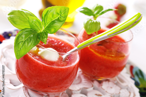 Photo: Delicious cold gazpacho soup with mozzarella and basil. Delicious cold gazpacho soup with mozzarella and basil.