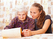 Young doctor holds the old  woman's hand