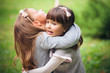 Happy little girlfriends in park