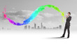 Businessman with colourful light beam in his hands