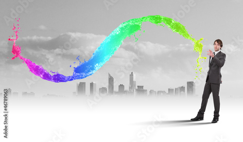 Photo: Businessman with colourful light beam in his hands Businessman with colourful light beam in his hands