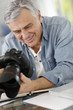 Photographer in office looking at camera screen