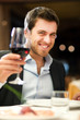 Man tasting a glass of red wine