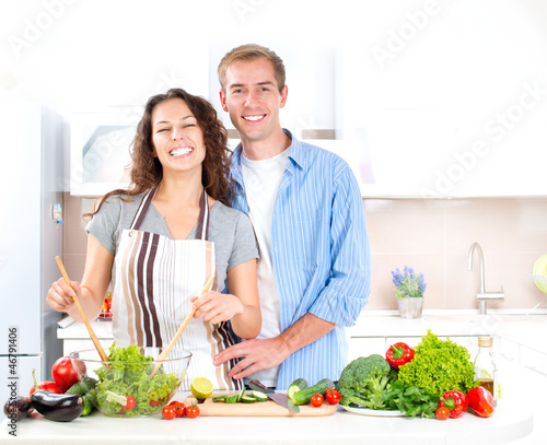 Photo: Happy Couple Cooking Together. Dieting. Healthy Food Happy Couple Cooking Together. Dieting. Healthy Food