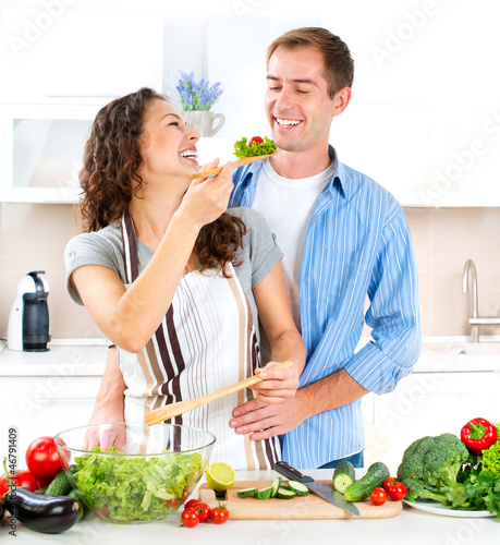 Photo: Happy Couple Cooking Together. Dieting. Healthy Food Happy Couple Cooking Together. Dieting. Healthy Food