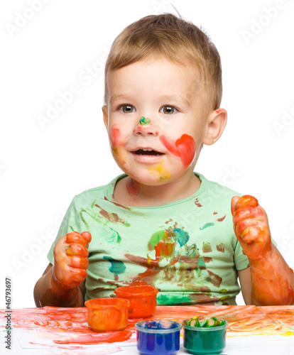 Photo: Little boy is playing with paints Little boy is playing with paints
