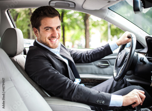 Photo: Handsome man driving his car Handsome man driving his car