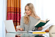attractive woman writing on laptop
