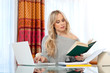attractive woman writing on laptop