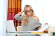 attractive woman writing on laptop
