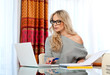 attractive woman writing on laptop