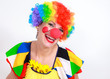 Clown looking to the copy space area in a white studio