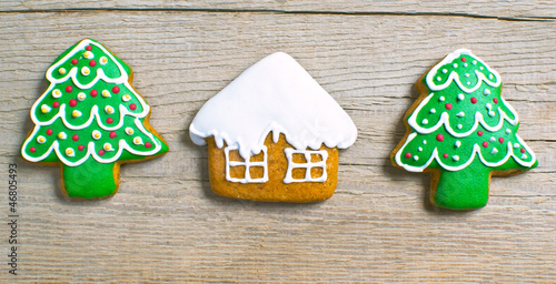 Photo: Christmas homemade gingerbread cookies over wooden table Christmas homemade gingerbread cookies over wooden table