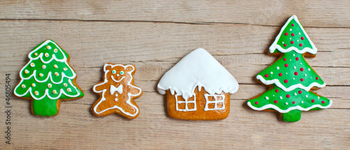 Photo: Christmas homemade gingerbread cookies over wooden table Christmas homemade gingerbread cookies over wooden table