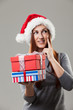 Photo: Beautiful woman in Santa hat with gifts Beautiful woman in Santa hat with gifts