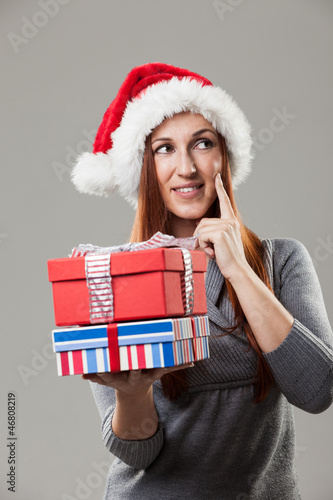 Photo: Beautiful woman in Santa hat with gifts Beautiful woman in Santa hat with gifts
