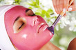 Young beautiful woman with cosmetic fruit facial mask at beauty