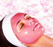 Photo: Young beautiful woman with moistening fruit facial mask at beaut Young beautiful woman with moistening fruit facial mask at beaut