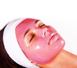 Young beautiful woman with moistening fruit facial mask at beaut