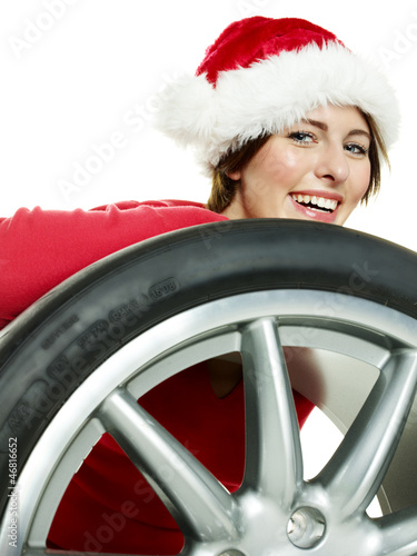 Photo: Miss santa behind a tire looking forward to christmas Miss santa behind a tire looking forward to christmas