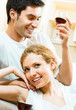 Cheerful couple with glasses of redwine