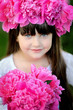 portrait of little girl outdoors with peony