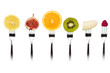Fruits slices on forks.