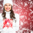 Beautiful young Christmas girl with a present.