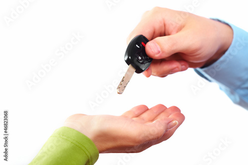 Photo: Hand with a car key. Hand with a car key.