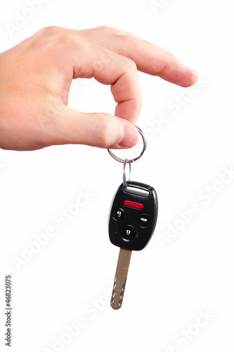 Photo: Hand with a car key. Hand with a car key.