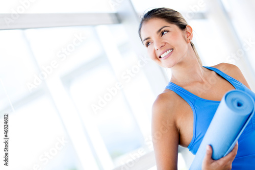 Photo: Gym woman with a yoga mat Gym woman with a yoga mat